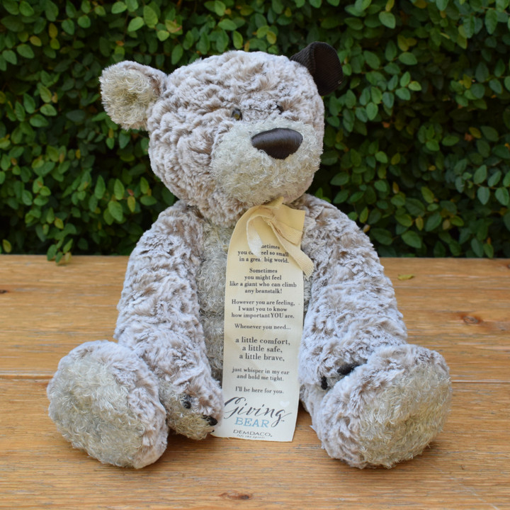 The Giving Bear is a wonderful gift to remind someone while they may be down, they are never alone. The plush bear is the perfect cuddle buddy, and his corduroy  show's he's always listening. He includes a bookmark sharing his message, "Sometimes you can feel so small in a great big world. Sometimes you might feel like a giant who can climb a beanstalk! However you are feeling, I want you to know how important YOU are. Whenever you need a little comfort, a little safe, a little brave, just whisper in my ear and hold me tight. I'll be here for you." The giving bear sits 12" tall and is 16" in total. 